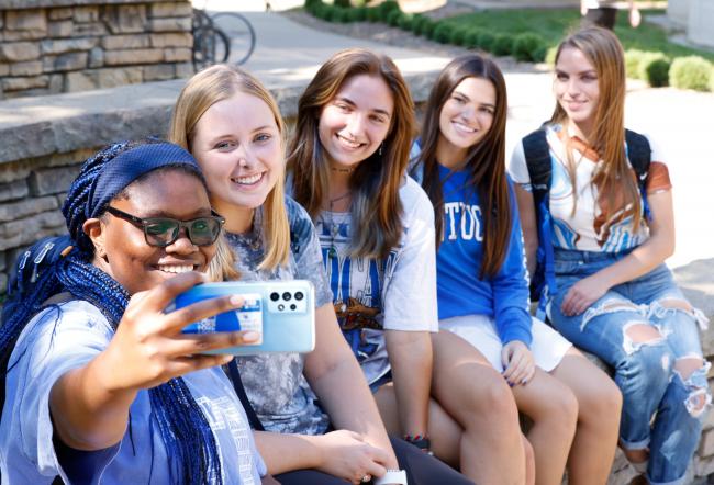 Students outside taking a selfie